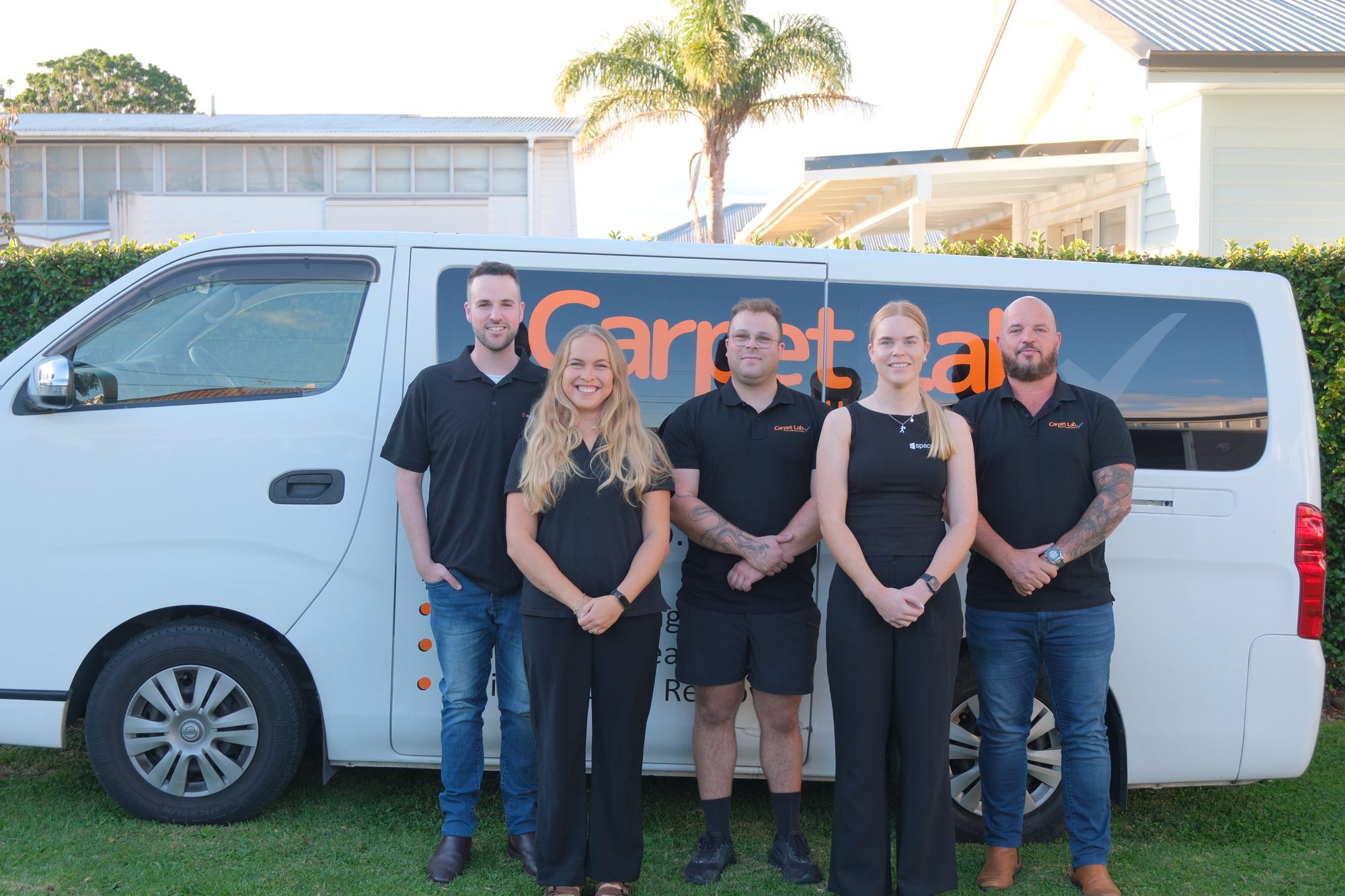 Carpet Lab team standing beside the branded service van in Auckland
