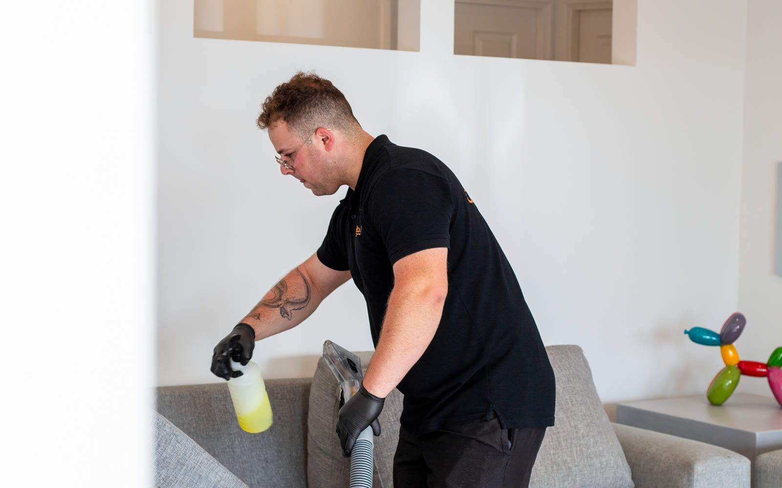 Carpet Lab technician preparing to clean a fabric sofa